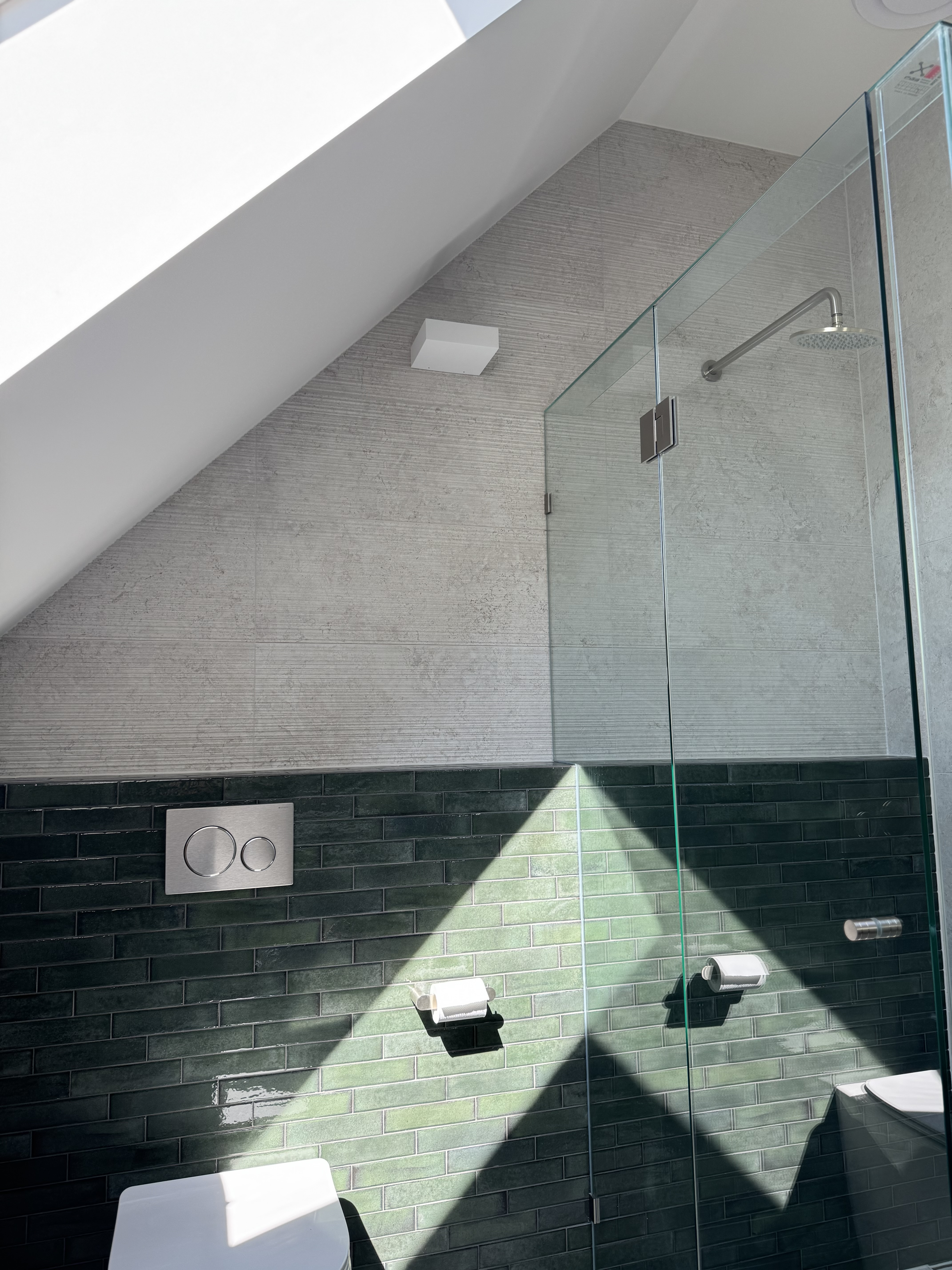 Bathroom — skylight casting geometric shadows on tile